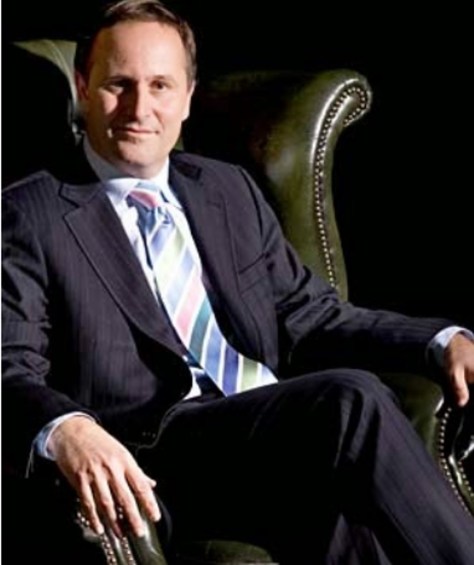 john key in an armchair