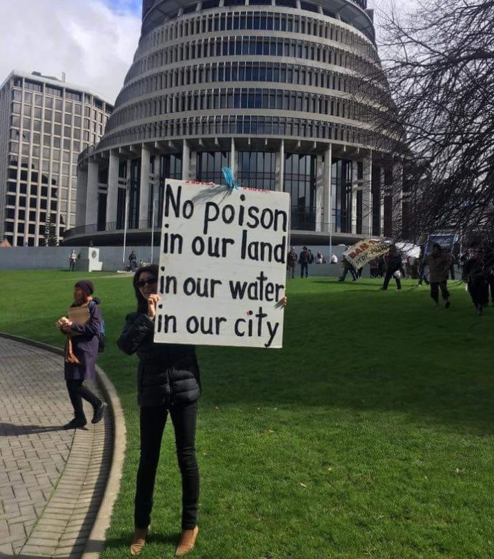 1080 poison protest at parliament nz beehive sign says no poison in our land water city