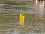 A sign submerged under flood waters