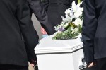 casket and pall bearers