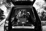 death, casket in hearse with flowers