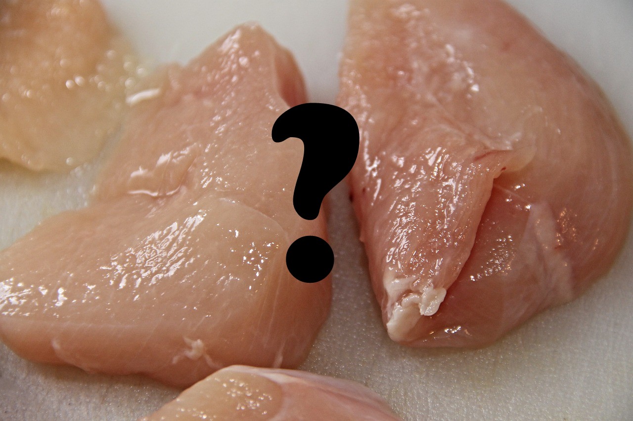 raw chicken breasts with a question mark