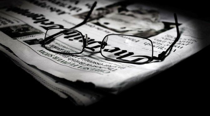 spectacles on folded newspaper
