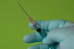 gloved hand with injection