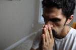 man in thought with hands in prayer position