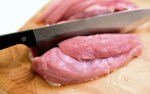 knife slicing raw meat